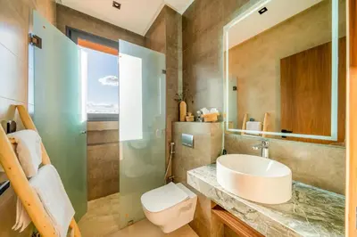 a bathroom with a sink and a toilet at Luxury 5-Suite Villa with private pool in GOLF Amlkis ,free Airport transport service in Marrakech