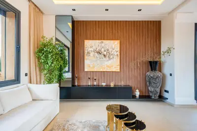 a living room with a couch and a table at Luxury 5-Suite Villa with private pool in GOLF Amlkis ,free Airport transport service in Marrakech