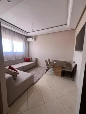 a living room with a couch and a table at M&O airport appartment in Marrakech