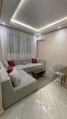 a living room with a couch and a table at M&O airport appartment in Marrakech