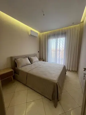 a bedroom with a large bed and a window at M&O airport appartment in Marrakech