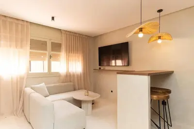 a living room with a white couch and a table at Studio de reve au Coeur de Marrakech in Marrakech