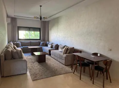 a living room with a couch and a table at Marrakech résidence Nour 6 in Marrakech