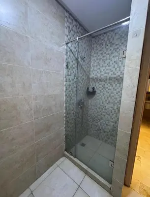 a shower with a glass door in a bathroom at Marrakech résidence Nour 6 in Marrakech