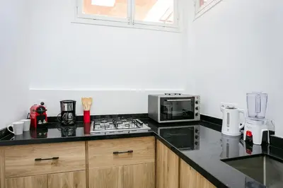 a kitchen with a stove top oven next to a microwave at Art Deco Loft 1BR Central Guéliz Marrakech in Marrakech