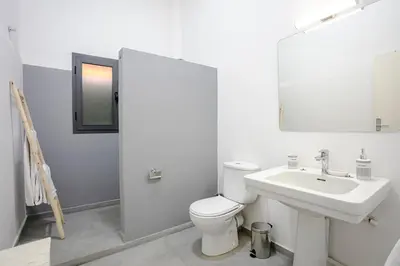 a white bathroom with a toilet and a sink at Art Deco Loft 1BR Central Guéliz Marrakech in Marrakech