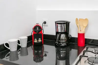 a kitchen counter with a coffee maker and cups on it at Art Deco Loft 1BR Central Guéliz Marrakech in Marrakech