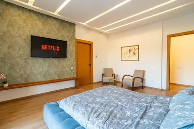 a bedroom with a bed and a tv on a wall at Zen Villa Private Parking in El Rhechat