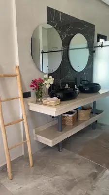 a bathroom counter with two sinks and two mirrors at Villa LAM atlas view in Tameslouht