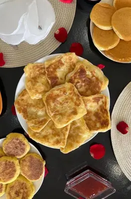 a plate of pancakes on a table with plates of food at Villa LAM atlas view in Tameslouht