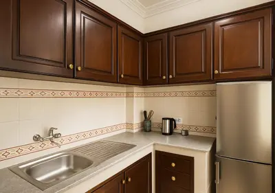 a kitchen with wooden cabinets and a stainless steel refrigerator at Séjour confortables et proche de tous in Marrakech