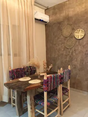 a dining room with a wooden table and chairs at Marrakech Authentic 2-Bedroom flat NearGueliz in Marrakech