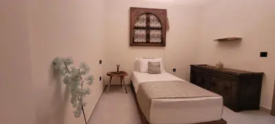 a bedroom with a bed and a dresser and a window at Marrakech Authentic 2-Bedroom flat NearGueliz in Marrakech