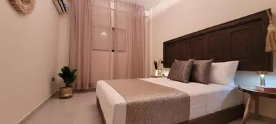 a bedroom with a large bed with a wooden headboard at Marrakech Authentic 2-Bedroom flat NearGueliz in Marrakech