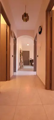 an empty hallway with a tile floor and a chandelier at Marrakech Authentic 2-Bedroom flat NearGueliz in Marrakech