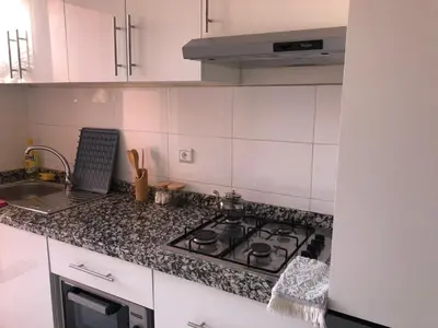 a white kitchen with a stove and a sink at Marrakech Authentic 2-Bedroom flat NearGueliz in Marrakech