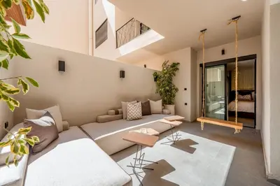 a living room with a large couch in a house at L'Amira - Super Apartment with Terrace - 2 people - Wifi in Marrakech