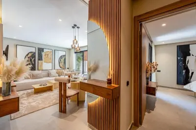 a living room with a table and a couch at L'Amira - Super Apartment with Terrace - 2 people - Wifi in Marrakech