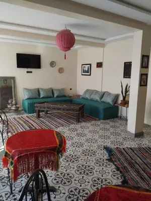 a living room with a couch and a table at Dar Kawtar in Marrakech