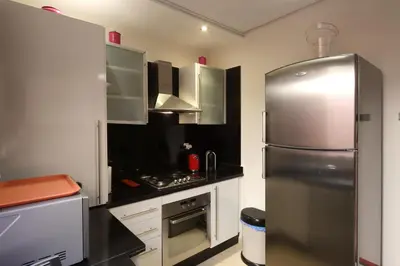a kitchen with a stainless steel refrigerator at Apartment in the Heart of Marrakech 5th Floor in Marrakech