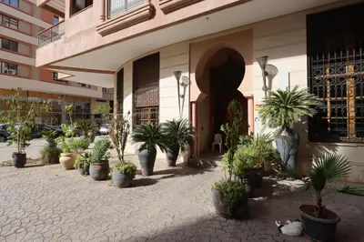 a courtyard with potted plants in front of a building at Apartment in the Heart of Marrakech 5th Floor in Marrakech