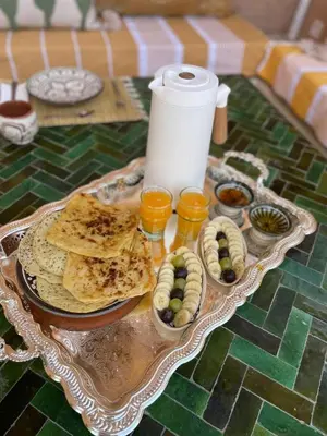 a table with a plate of food and some snacks at Riad La Brune in Marrakech