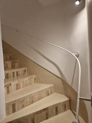 a set of stairs with a light on the wall at Riad La Brune in Marrakech