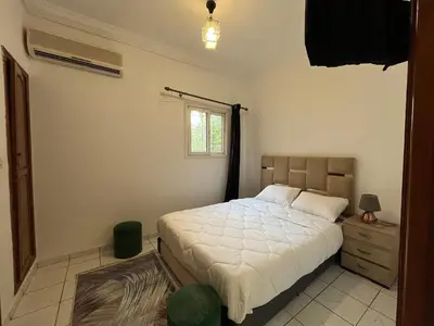 a bedroom with a white bed and a window at Riad Flouris in marrakech in Marrakech