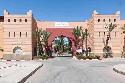a large building with a gate in the middle of a street at Riad Flouris in marrakech in Marrakech
