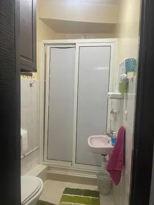 a white bathroom with a sink and a toilet at Apparemment alhamra in Marrakech