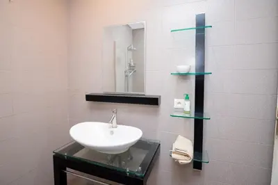 a bathroom with a sink and a mirror at Gueliz carree Eden apartment in Marrakech