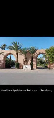 a building with two arches with palm trees in it at Pure havre de paix à Marrakech in Marrakech