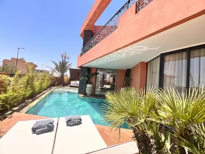 a house with a swimming pool next to a building at luxury 5 bedroom home in Marrakech