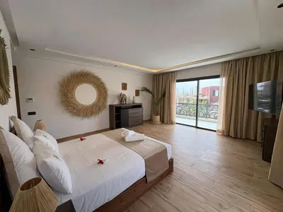a large bedroom with a large bed and a mirror at luxury 5 bedroom home in Marrakech
