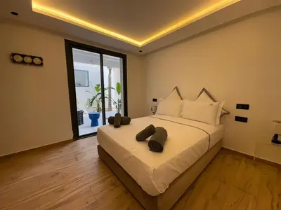 a bedroom with a large bed with two hats on it at luxury 5 bedroom home in Marrakech