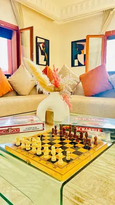 a chess board on a table in a living room at Heart of Marrakech Chic & Central Gueliz Apartment - Free parking in Marrakech