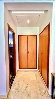 a room with two wooden doors and a tile floor at Palmeraie 1BR Appart with Garden, Pools and Tennis in Marrakech