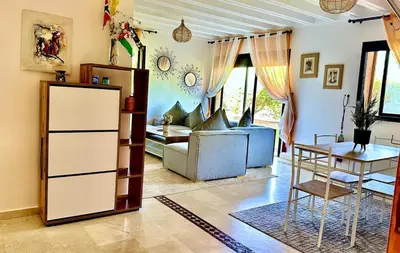 a living room with a couch and a table at Palmeraie 1BR Appart with Garden, Pools and Tennis in Marrakech