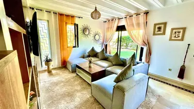 a living room with a couch and a table at Palmeraie 1BR Appart with Garden, Pools and Tennis in Marrakech