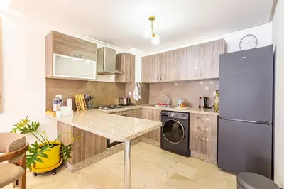 a kitchen with a stainless steel refrigerator and a dishwasher at Luxe et Élégance au cœur de Marrakech in Marrakech