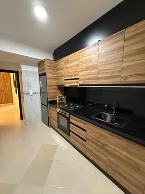 a kitchen with wooden cabinets and a sink at Pas disponible in Marrakech