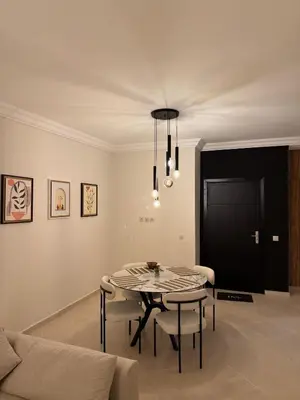 a dining room with a table and a couch at Pas disponible in Marrakech