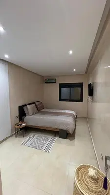 a bedroom with a bed and a television in it at Appartement Design près du Jardin Majorelle in Marrakech