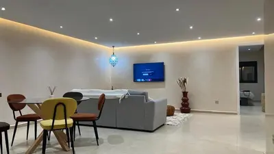 a living room with a couch and a table with chairs at Appartement Design près du Jardin Majorelle in Marrakech