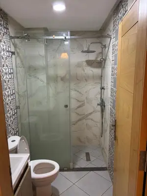 a bathroom with a glass shower with a toilet at Marrakech,Rouidate in Marrakech