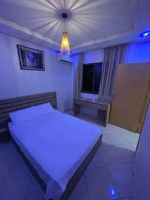 a bedroom with a white bed and a light at Marrakech,Rouidate in Marrakech