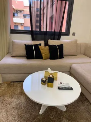 a living room with a couch and a white coffee table at Comfort Luxe 2BR Pool & Balcony in Marrakech