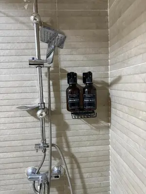 a shower with two bottles of soap on a wall at Comfort Luxe 2BR Pool & Balcony in Marrakech