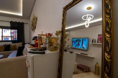 a living room with a mirror and a couch at Comfort Luxe 2BR Pool & Balcony in Marrakech