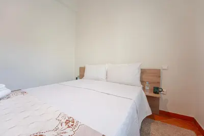 a white bed with white sheets and pillows at Charming Central 2 Bedroom Apartment with Pool Near Train Station in Marrakech